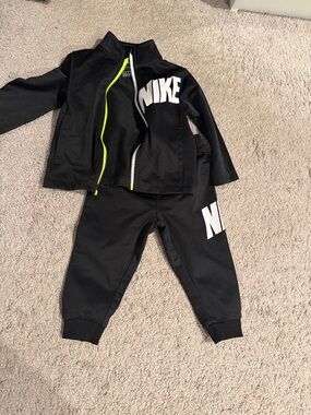 Nike Black Kids Two-Piece Tracksuit with White Logo and Neon Zipper